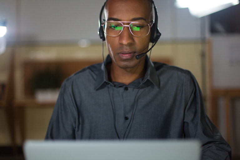 Concentrated call center operator talking with client